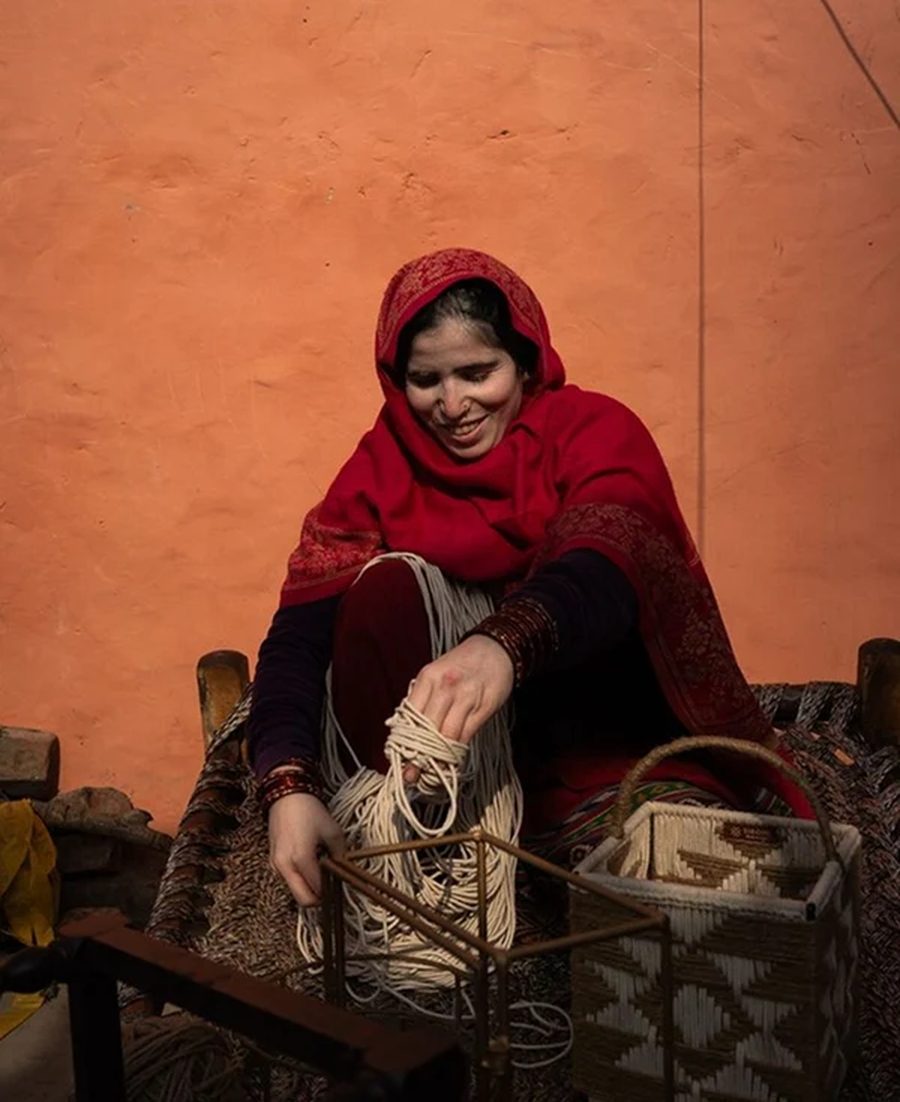 An artisan winding cotton cord before weaving